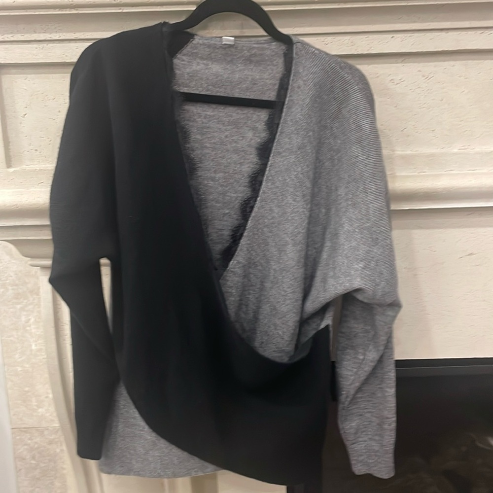 Black and grey lace trimmed criss cross thin sweater. Size large. Never worn.